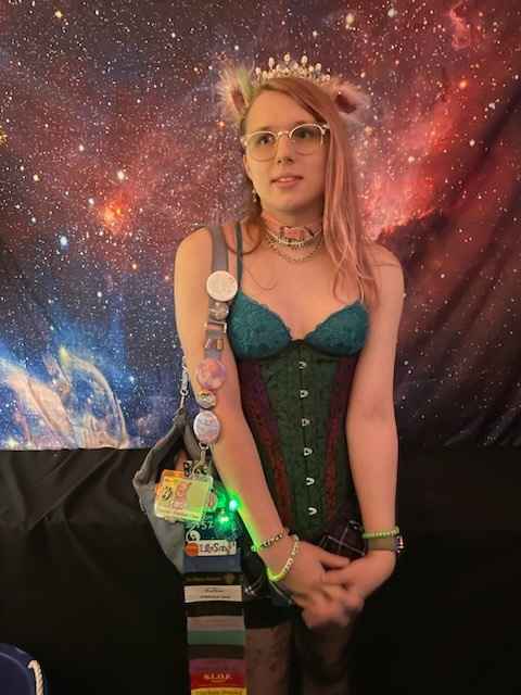 A picture of me from Minicon 57 wearing a colorful corset.